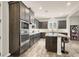 A well-designed kitchen with stainless steel appliances, dark wood cabinets, and hardwood floors at 8245 Broad Branch Way, Las Vegas, NV 89113