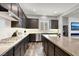 Modern kitchen features dark wood cabinets, quartz countertops, and stainless steel appliances at 8245 Broad Branch Way, Las Vegas, NV 89113