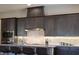 Modern kitchen with pendant lights, stainless steel appliances, granite counters and wood cabinets at 8245 Broad Branch Way, Las Vegas, NV 89113