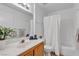 This bathroom boasts a clean, modern design with a white vanity, tub and shower, and a decorative plant at 8410 Eldora Ave # 2045, Las Vegas, NV 89117