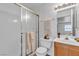 Bathroom featuring shower with glass doors, vanity with sink and mirror, plus ample lighting and towel rack at 8410 Eldora Ave # 2045, Las Vegas, NV 89117