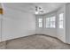 Comfortable bedroom with plush carpet, a ceiling fan, and large windows for ample natural light at 8410 Eldora Ave # 2045, Las Vegas, NV 89117