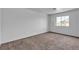 This bright bedroom is a blank canvas, offering neutral carpet and ample natural light from a large window at 8410 Eldora Ave # 2045, Las Vegas, NV 89117