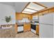 Bright and tidy kitchen with light wood cabinets and white appliances, ready for move-in at 8410 Eldora Ave # 2045, Las Vegas, NV 89117