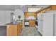 The kitchen has laminate countertops, light wood cabinets, white appliances and leads to living area at 8410 Eldora Ave # 2045, Las Vegas, NV 89117