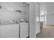 Convenient laundry room features a stacked washer and dryer, plus storage shelves for linens and laundry essentials at 8410 Eldora Ave # 2045, Las Vegas, NV 89117