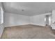 Expansive living room showcasing neutral carpet and ample space, transitioning smoothly into the kitchen at 8410 Eldora Ave # 2045, Las Vegas, NV 89117