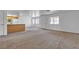 Open-concept living room featuring neutral carpet, ample natural light and a view into the kitchen at 8410 Eldora Ave # 2045, Las Vegas, NV 89117