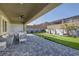 Outdoor living area with covered patio and backyard putting green for recreation and relaxation at 12438 Heritage Bend Dr, Las Vegas, NV 89138