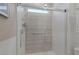 Modern bathroom with frameless glass shower, horizontal tile surround, and convenient grab bar at 12438 Heritage Bend Dr, Las Vegas, NV 89138