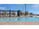 Luxury community pool featuring lounge chairs and shade structure at 12438 Heritage Bend Dr, Las Vegas, NV 89138