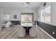 Bright dining area with black accent wall, wood floors, and sliding glass doors to the backyard at 12438 Heritage Bend Dr, Las Vegas, NV 89138