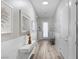 Bright hallway with modern white wood paneling, light-toned wood floors, and stylish decor at 12438 Heritage Bend Dr, Las Vegas, NV 89138