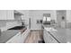 Spacious kitchen with a large island, white cabinets, and modern stainless steel appliances at 12438 Heritage Bend Dr, Las Vegas, NV 89138