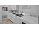 Well-lit laundry room featuring a front-load washer and dryer, white cabinetry, and modern finishes at 12438 Heritage Bend Dr, Las Vegas, NV 89138