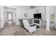 Cozy living room with a fireplace, modern furnishings, and plenty of natural light at 12438 Heritage Bend Dr, Las Vegas, NV 89138