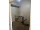 Carpeted hallway with a black metal handrail and a view of the stairway at 2541 Love St, Las Vegas, NV 89121
