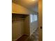 Hallway with wood-look floors, a closet and a window providing natural light at 2541 Love St, Las Vegas, NV 89121