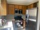 Functional kitchen featuring stainless steel appliances, tile countertops and warm wood cabinetry at 2541 Love St, Las Vegas, NV 89121