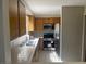 Bright kitchen showcasing tile countertops, stainless steel appliances, and warm wood cabinetry at 2541 Love St, Las Vegas, NV 89121