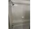 Clean shower with white tiled walls, a built-in seat, and chrome fixtures at 2541 Love St, Las Vegas, NV 89121