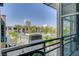 Balcony view of a modern building, swimming pool, palm trees, and cityscape at 353 E Bonneville Ave # 754, Las Vegas, NV 89101