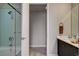 This bathroom features a tiled shower with glass door, modern vanity with double sinks, and neutral paint at 353 E Bonneville Ave # 754, Las Vegas, NV 89101