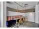 A modern dining area features a purple banquette, modern lighting and seating for six at 353 E Bonneville Ave # 754, Las Vegas, NV 89101