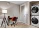 Cozy home office featuring wood-look floors, a modern desk setup, and an in-unit washer and dryer at 353 E Bonneville Ave # 754, Las Vegas, NV 89101