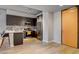 Sleek kitchen features a breakfast bar, stainless steel appliances, gray cabinets, and tile backsplash adjacent to entry door at 353 E Bonneville Ave # 754, Las Vegas, NV 89101