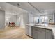 Modern kitchen with stainless steel appliances and breakfast bar overlooks a living space with natural light and contemporary style at 353 E Bonneville Ave # 754, Las Vegas, NV 89101