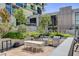 Modern outdoor kitchen features stainless steel appliances, a dining table, and manicured landscaping at 353 E Bonneville Ave # 754, Las Vegas, NV 89101
