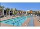Resort-style pool area with palm trees, lounge chairs, and a clear blue swimming pool at 353 E Bonneville Ave # 754, Las Vegas, NV 89101