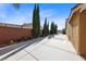 View of the backyard featuring tall trees and a pickle ball court at 496 Grassrange Ln, Henderson, NV 89052