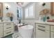 Bright bathroom featuring double sinks, bathtub, and luxury finishes at 496 Grassrange Ln, Henderson, NV 89052
