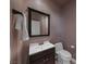 This bathroom features a toilet, mirror, and sink with vanity at 496 Grassrange Ln, Henderson, NV 89052