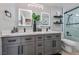 Beautiful bathroom featuring double sinks, gray cabinets, modern fixtures, and a glass shower at 496 Grassrange Ln, Henderson, NV 89052