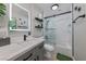 Modern bathroom featuring sleek vanity, an illuminated mirror, and a glass enclosed tub and shower at 496 Grassrange Ln, Henderson, NV 89052