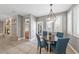 Inviting dining nook with a modern chandelier and plantation shutters, adjacent to a fireplace and open floor plan at 496 Grassrange Ln, Henderson, NV 89052