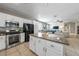 Well-equipped kitchen showcasing stainless steel appliances, a center island, and tile backsplash at 496 Grassrange Ln, Henderson, NV 89052