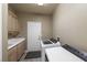 Bright laundry room featuring modern washer and dryer, cabinets and a countertop at 496 Grassrange Ln, Henderson, NV 89052