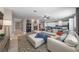 Open concept living room featuring a large sectional sofa, fireplace, and tile flooring at 496 Grassrange Ln, Henderson, NV 89052