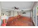 Large living room with hardwood flooring, ceiling fans, and access to the backyard at 496 Grassrange Ln, Henderson, NV 89052