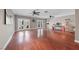 Spacious living room with hardwood floors, ceiling fans, and access to the patio at 496 Grassrange Ln, Henderson, NV 89052