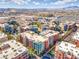 An aerial view captures colorful condo buildings with mountain views, showcasing the community's urban setting at 50 E Serene Ave # 107, Las Vegas, NV 89123