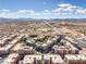 An aerial perspective highlights the interconnected condo buildings and surrounding residential areas, capturing a view of the mountains at 50 E Serene Ave # 107, Las Vegas, NV 89123