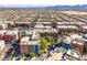View of Las Vegas condos with a pool, landscaping, and city skyline in the distance. Great location! at 50 E Serene Ave # 107, Las Vegas, NV 89123