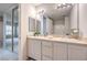 Bathroom with double vanity, mirror, and a view to the main living area and the shower at 50 E Serene Ave # 107, Las Vegas, NV 89123