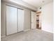 Bedroom with carpeted floor, sliding door closet, and view to living area through doorway at 50 E Serene Ave # 107, Las Vegas, NV 89123