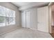 Bedroom with carpeted floors, closet, and window with light-blocking blinds at 50 E Serene Ave # 107, Las Vegas, NV 89123